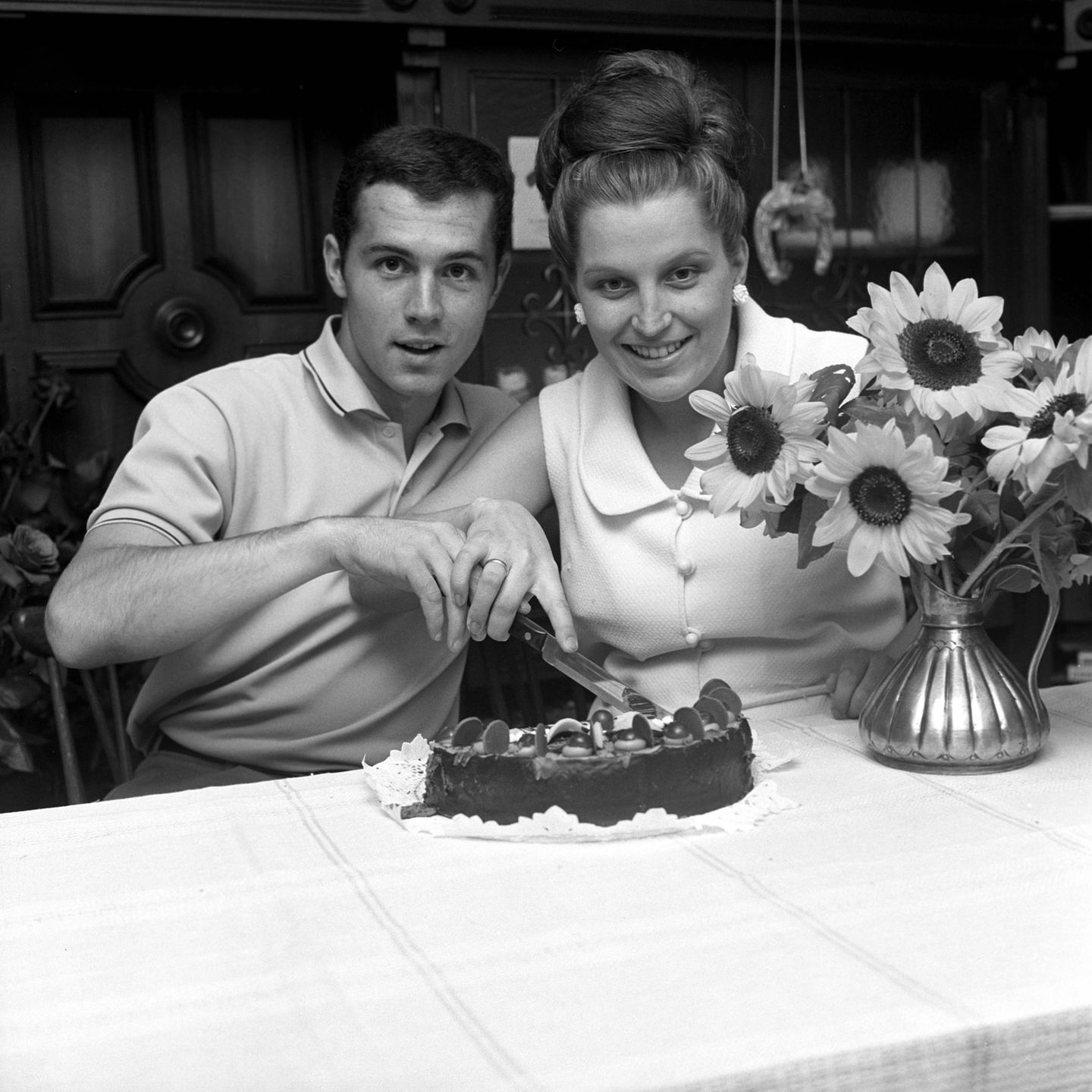 Franz Beckenbauer und Ehefrau Brigitte mit einem Sonnenblumenstrauss
