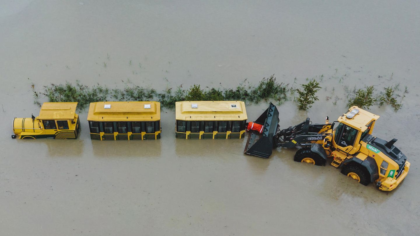 In Hollersbach im Salzburger Land fiel eine kleine Eisenbahn dem Hochwasser zum Opfer. Rettungskräfte mussten sich aus einer Baggerschaufel heraus lehnen, um die Wagons zu befreien