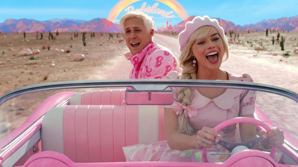 Ryan Gosling als Ken und Margot Robbie als Barbie sitzen im Film in einem Cabrio "Barbie."