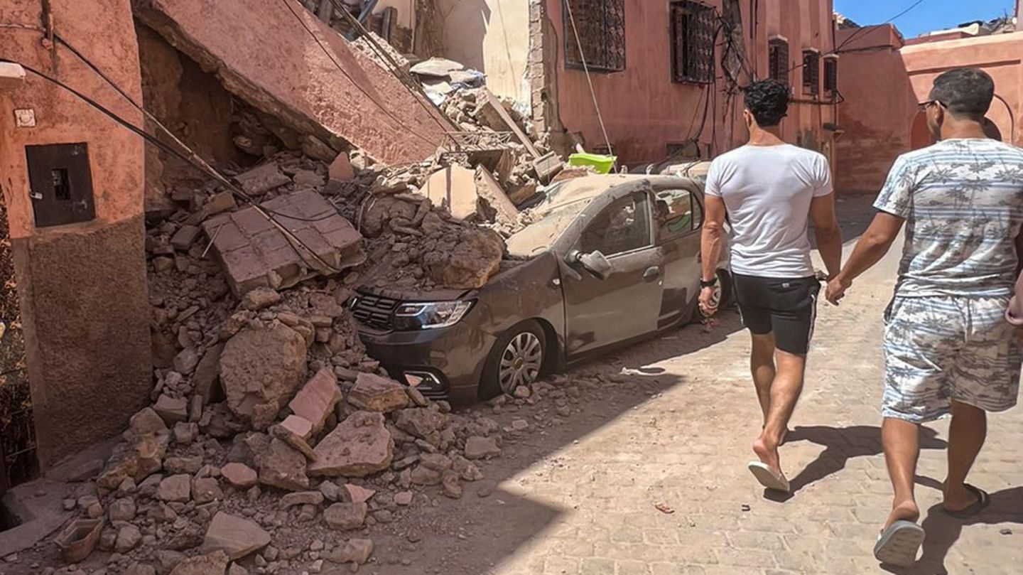 Die beiden Männer in Marrakesch sind offenbar ohne Schaden davon gekommen und begutachten die Verwüstungen in ihrer Nachbarschaft.