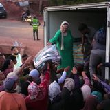 Helfer verteilen Decken bei den Menschen, die durch das Erdbeben obdachlos geworden sind