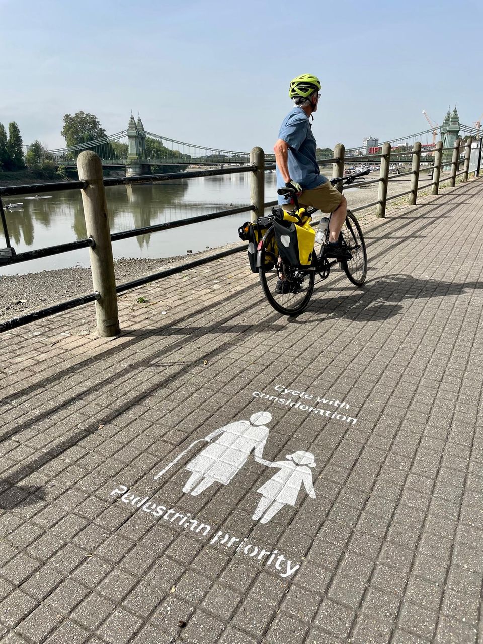"Cycle considerately - pedestrians have priority here" is written on the Thames Path, which is shared by pedestrians and cyclists in Hammersmith