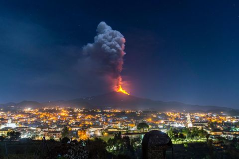 Der Ätna auf Sizilien spuckt Feuer in den Nachthimmel über der Stadt Pedara