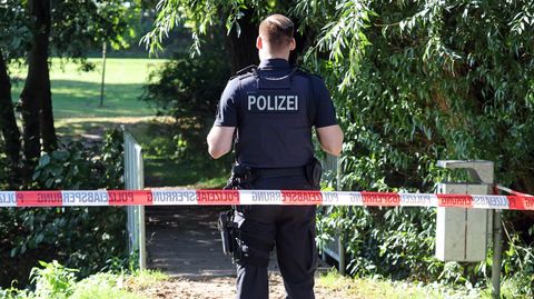 Ein Polizist sichert den abgesperrten Fundort am See Pragsdorf bei Neubrandenburg ab.