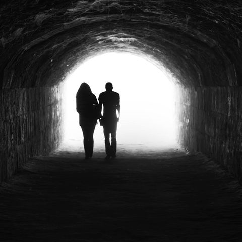 Umriss einer Frau und eines Mannes in einem Tunnel