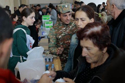Armenien, Goris: Ethnische Armenier aus Bergkarabach warten in einem provisorischen Lager auf humanitäre Hilfe. Nach dem Angriff auf das Gebiet durch Aserbaidschan fliehen immer mehr Menschen nach Armenien