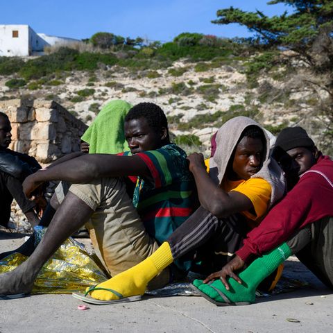 Auf Lampedusa angekommene Geflüchtete warten auf ihre Registrierung
