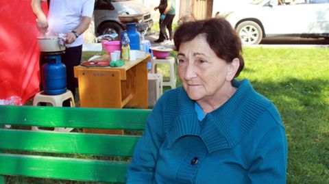 Vayk, Armenien. Die 68-jährige Schasmin sitzt nach ihrer mehrtägigen Flucht aus Bergkarabach erschöpft auf einer Bank