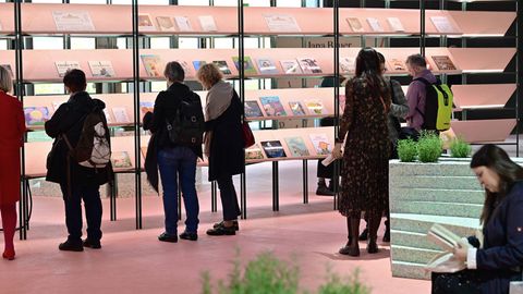 Menschen stöbern in einem Regal auf der Frankfurter Buchmesse