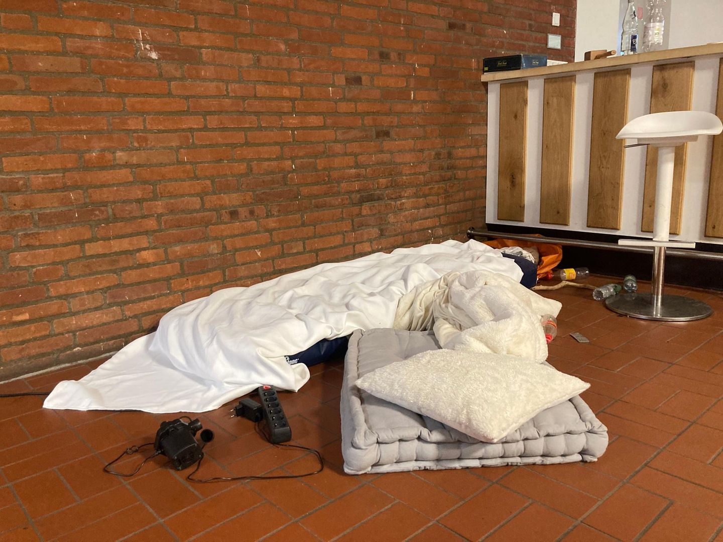 Eine Matratze auf dem Boden und ein paar persönliche Gegenstände auf dem Boden, so sieht eine exemplarische Schlafstätte aus