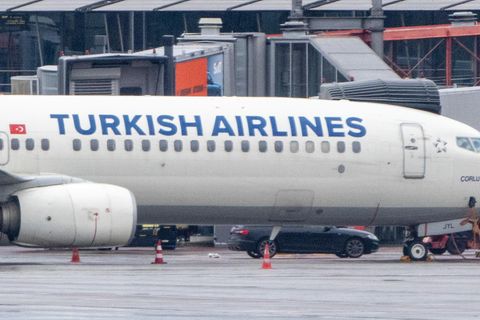 Ein Auto steht am Flughafen Hamburg unter einer Linienmaschine der Turkish Airlines