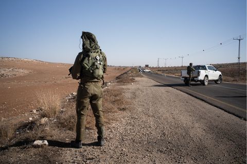 Israelische Soldaten stehen an einer Straße im Westjordanland
