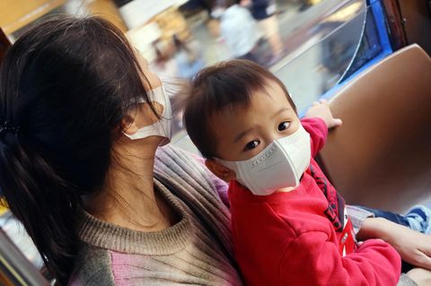 Hong Kong, China: Ein Kind trägt in einem Bus eine FFP2-Maske, Aufnahme vom 09.12.2022