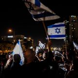 Menschen jubeln mit israelischen Fahnen