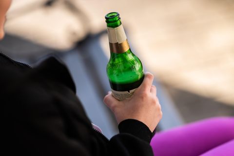 Jugendlicher hält Alkohol in der Hand