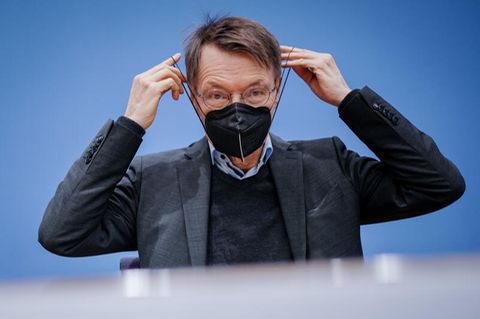 Gesundheitsminister Karl Lauterbach setzt eine FFP2-Maske auf
