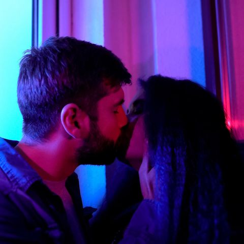 Ein junges Paar knutscht in einem Club