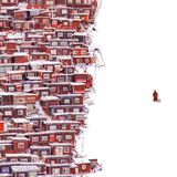 Ein Mönch zieht einen Trolli durch den Schnee neben sich eine Siedlung aus Holzhäusern