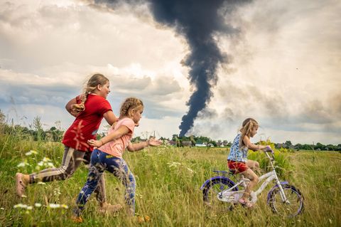 Unter den dunklen Wolken des Krieges übt die fünfjährige Alina, begleitet von Freundinnen, das Fahrradfahren auf einer Wiese im Nordwesten der Ukraine - ein Moment der Unbeschwertheit. In der Nacht zuvor hat eine russische Drohne hier ein Öllager in Brand gesetzt