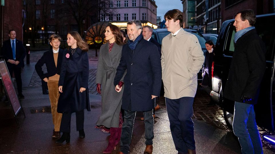 Holding hands, Crown Prince Frederik and his wife, Crown Princess Mary, arrive with their children at the Christmas service