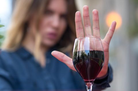 Frau zeigt mit ihrer Hand, dass sie keinen Alkohol will