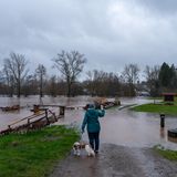 Eine Frau fotografiert am Mittwochmorgen mit einem Smartphone das Hochwasser der Glan in Altenglan-Patersbach