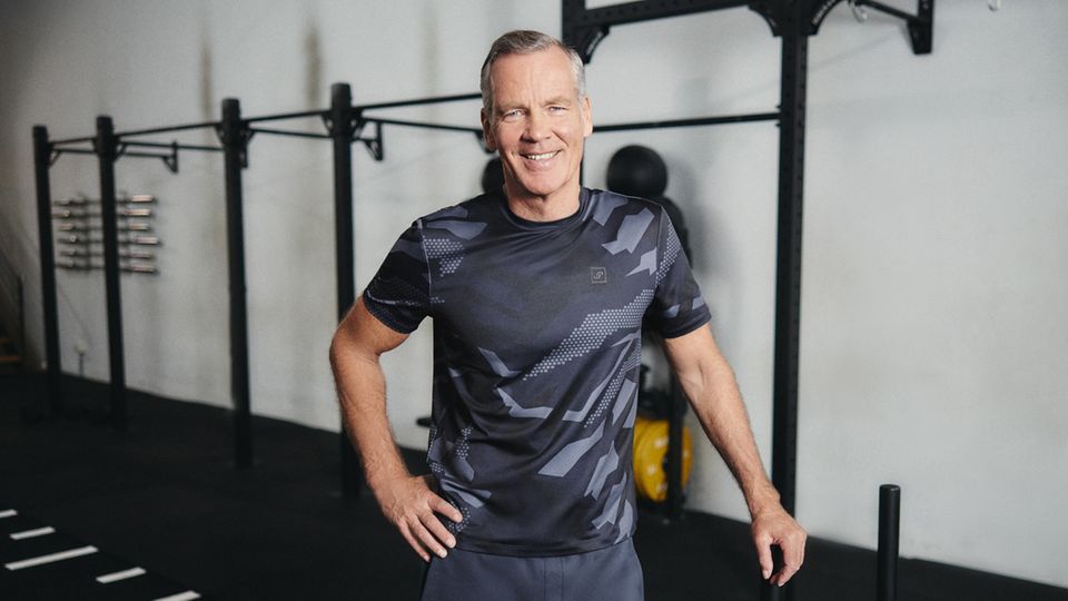 Henry Maske in grauer Sportkleidung in einem Fitnessstudio