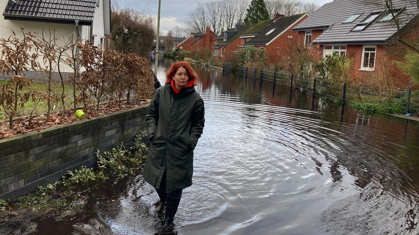 Daina Kuniga-Wendel watet durch das Hochwasser in ihrer Straße in Lilienthal