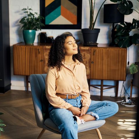 FRau sitzt auf einem Stuhl uns ist ausgeglichen