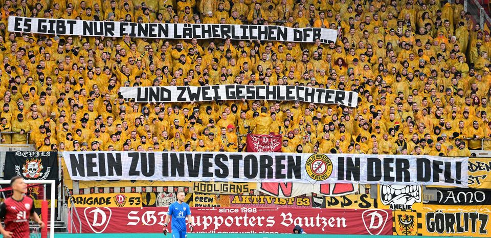 Dynamo Dresden fans hold up a banner that says there are only two genders Dynamo Dresden fans hold up a banner that says there are only two genders