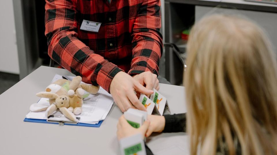 Therapeut Robin Zimmermann spielt Karten mit seinem Patienten