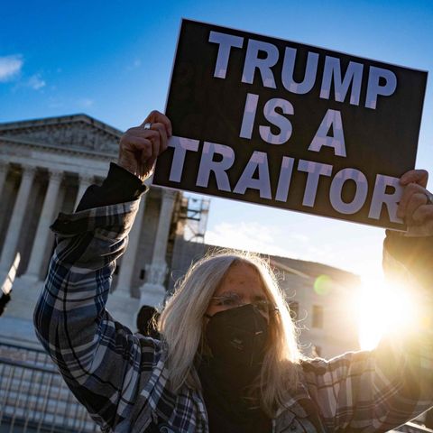 Trump als "Verräter": Eine Demonstrantin vor dem Supreme Court in Washington. Dort haben die Richter am Donnerstag begonnen, über einen möglichen Ausschluss des Ex-Präsidenten von den Wahlen zu entscheiden