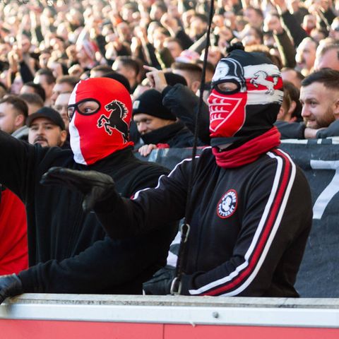 Fans des VfB Stuttgart werfen fröhlich Tennisbälle
