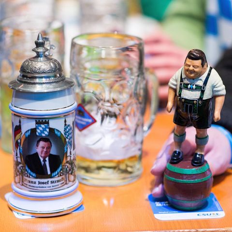 Auf dem Politischen Aschermittwoch sind eine Figur von Franz Josef Strauß und ein Bierkrug mit seinem Gesicht darauf zu sehen