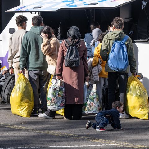 Flüchtlinge stehen vor der hessischen Erstaufnahmeeinrichtung (HEAE) in Gießen