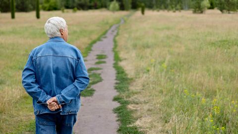 Älterer mann auf einem Feldweg