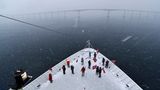 Im dichten Schneetreiben geht es unter der 30 Meter hohen Sortland-Brücke hindurch, um für eine halbe Stunde mittags in Sortland auf den Vesterålen anzulegen.