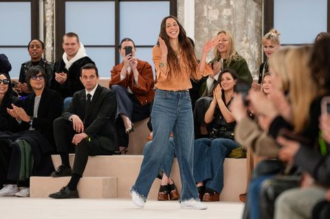 Designerin Chemena Kamali, in Jeans und Bluse, bedankt sich bei ihrem Laufsteg-Publikum