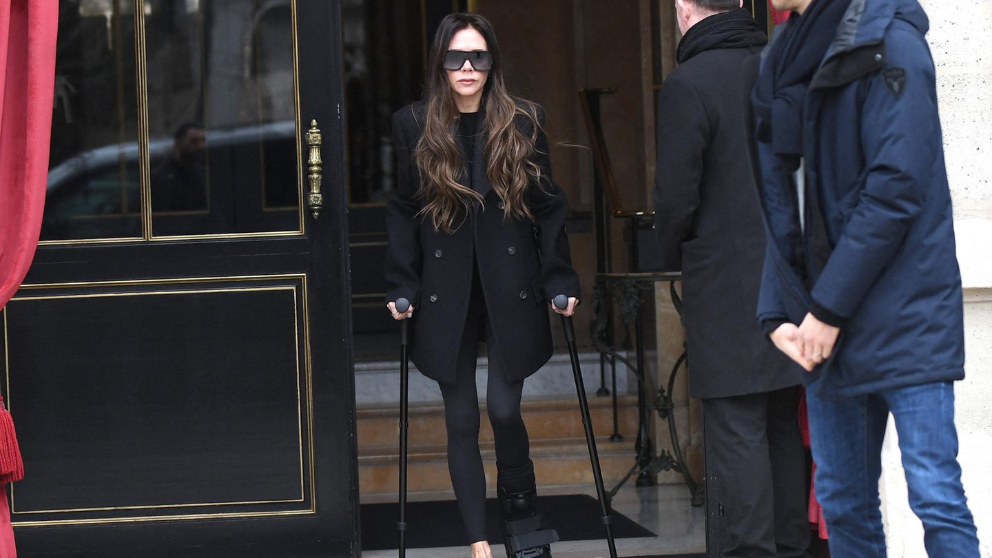 People today: Victoria Beckham hobbles through Paris on crutches