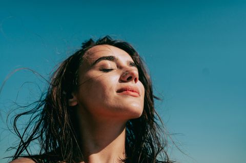 Symbolbild People Pleaser, Mut zum Nein sagen: Eine Frau lässt dich die Sonne ins Gesicht scheinen.