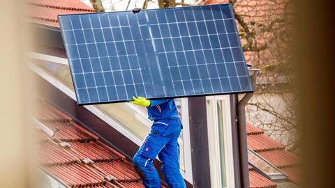 Installation einer Solaranlage auf einem privaten Hausdach in München. Der Ausbau von PV schritt 2023 gut voran, aber noch nicht schnell genug, um die Ausbauziele der Bundesregierung bis 2030 zu schaffen.