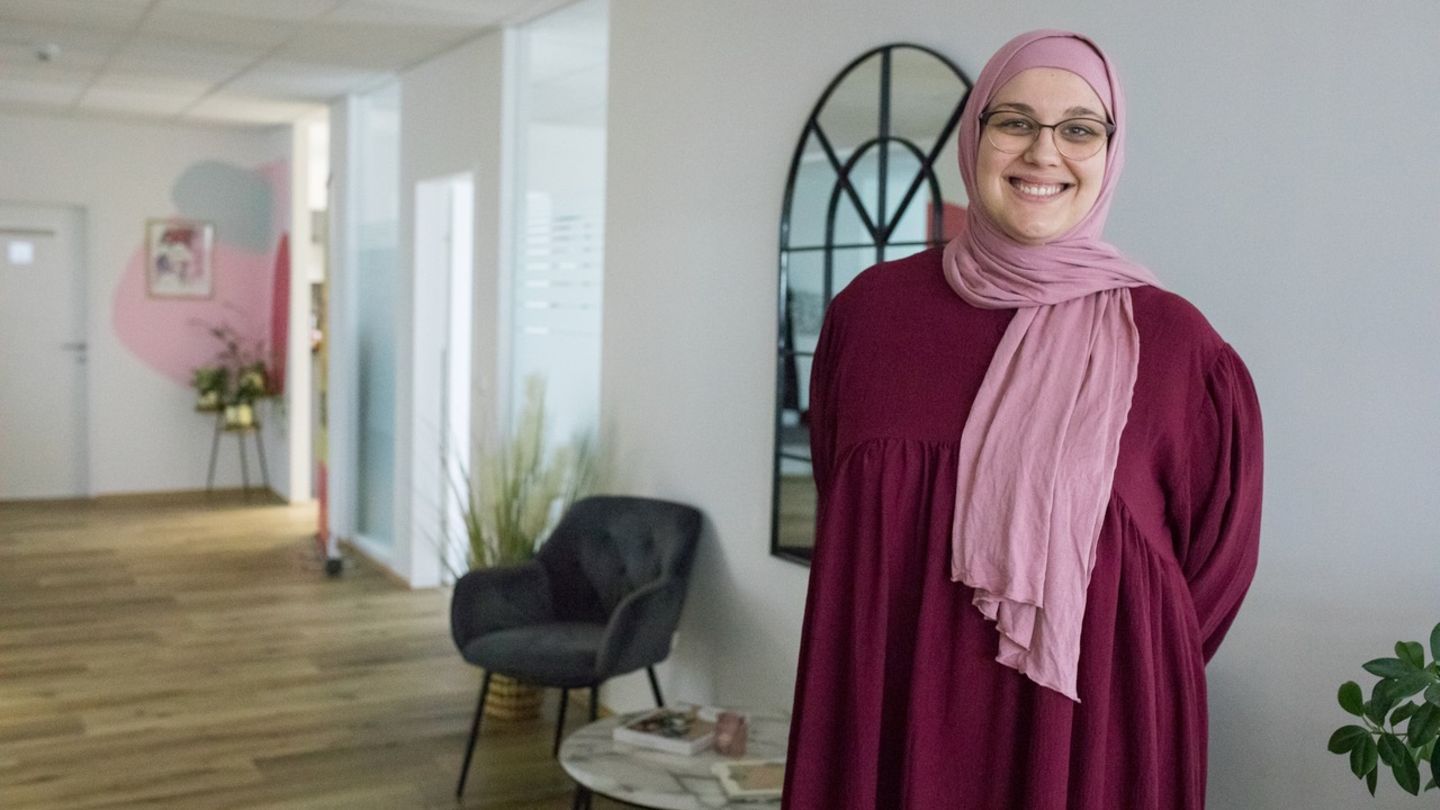 Muslima Magdalena Zidi steht in ihrer Praxis und trägt ein Koptuch