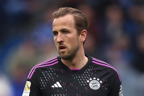 Harry Kane steht im schwarz-violetten Trikot des FC Bayern München auf dem Fußballplatz