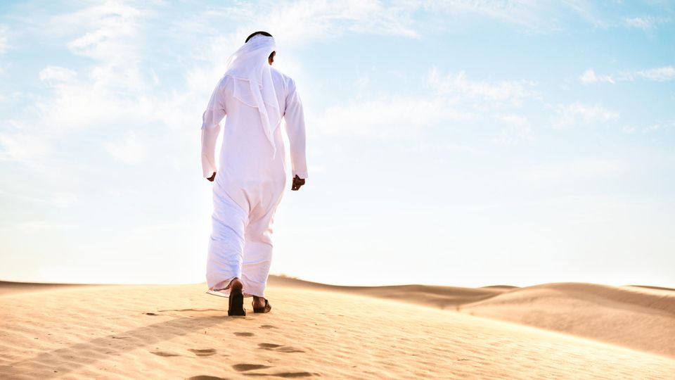 Ein arabischer Mann von hinten in der Wüste