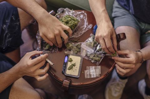 Zwei Männer wiegen Cannabis und verteilen es in Tüten