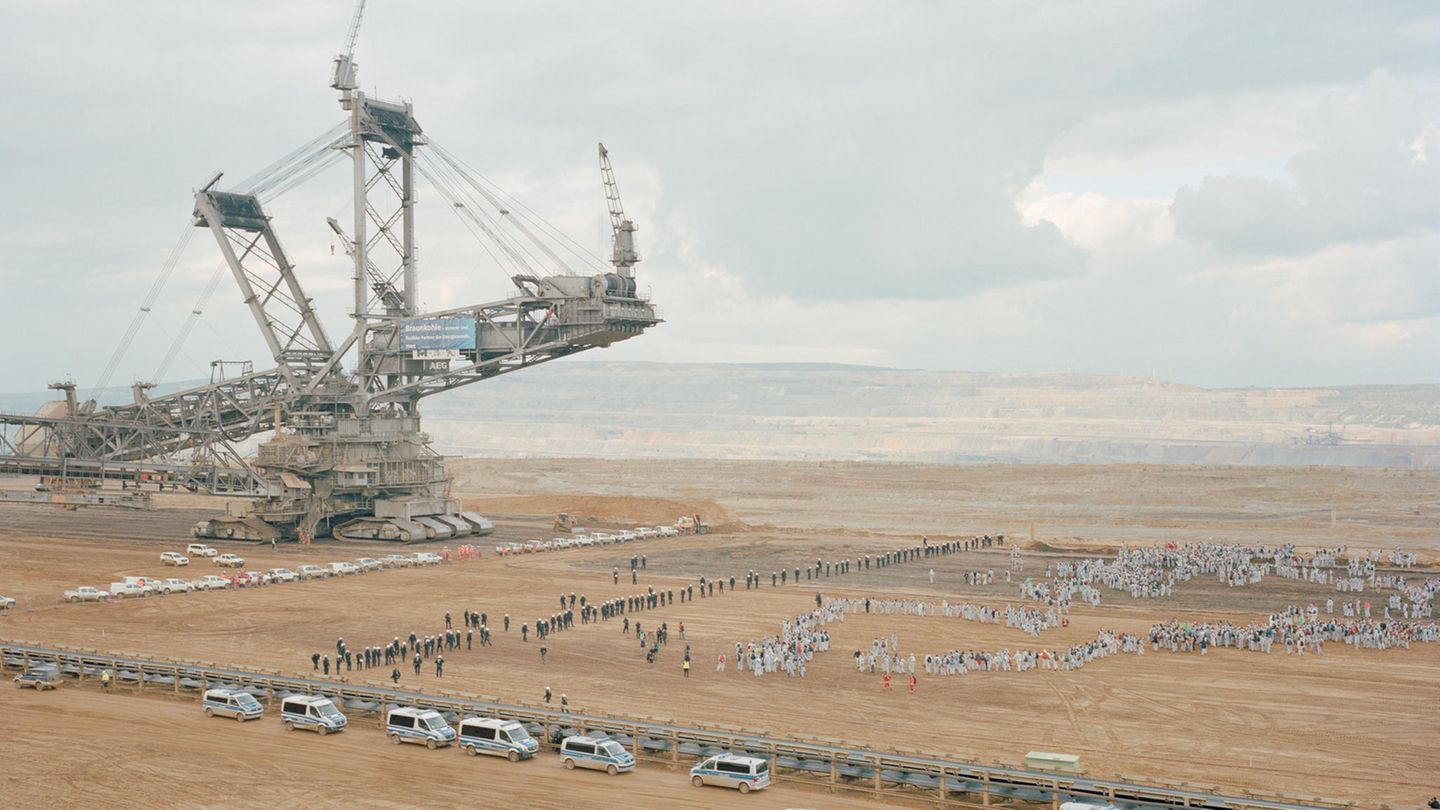 Aktivisten bewegen sich auf einen riesigen Braunkohlebagger zu