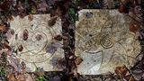 Verzierte Bodenplatten zwischen Laub