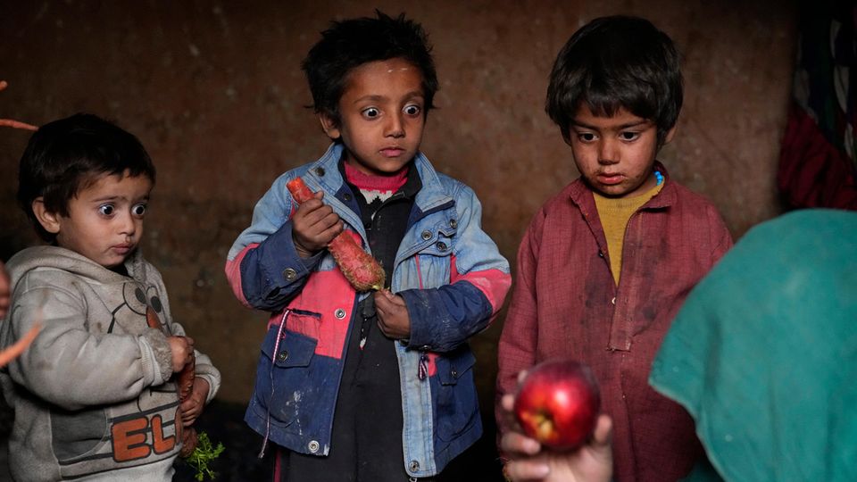 World Press Photo: Kinder in Afghanistan gucken mit großen Augen auf einen Apfel
