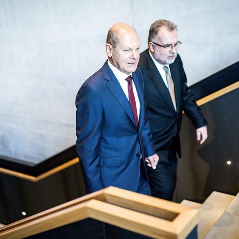 Bundeskanzler Olaf Scholz (SPD) geht neben Siegfried Russwurm, BDI-Präsident