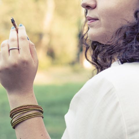 Frau hält einen Joint in der Hand